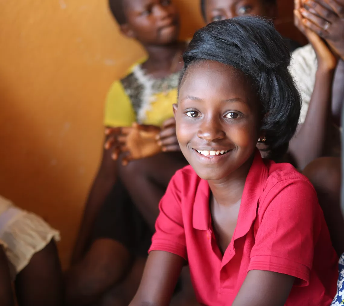 A girl smiles in a classroom, Sierra Leone