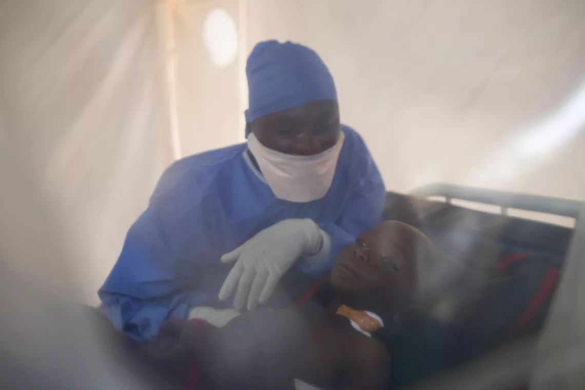 Democratic Republic of Congo. A caregiver at the Ebola Treatment Centre of Butembo sits with a child affected by the virus in North Kivu Province.