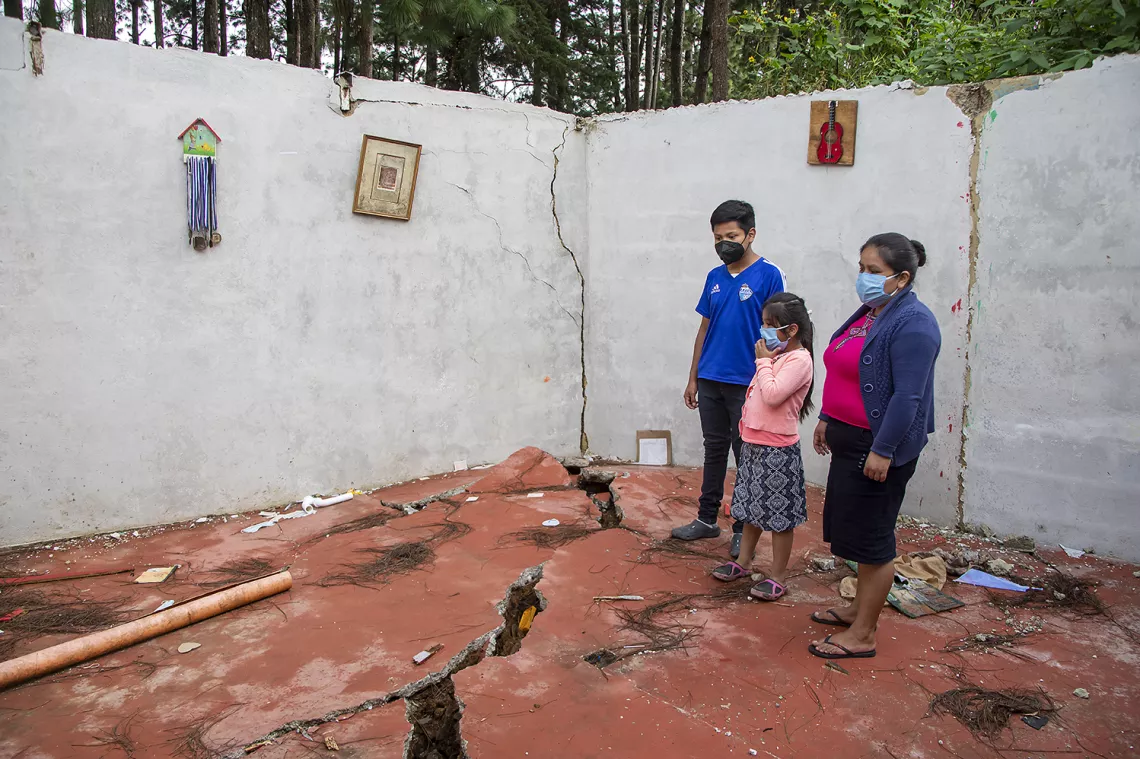 A family assesses their destroyed property