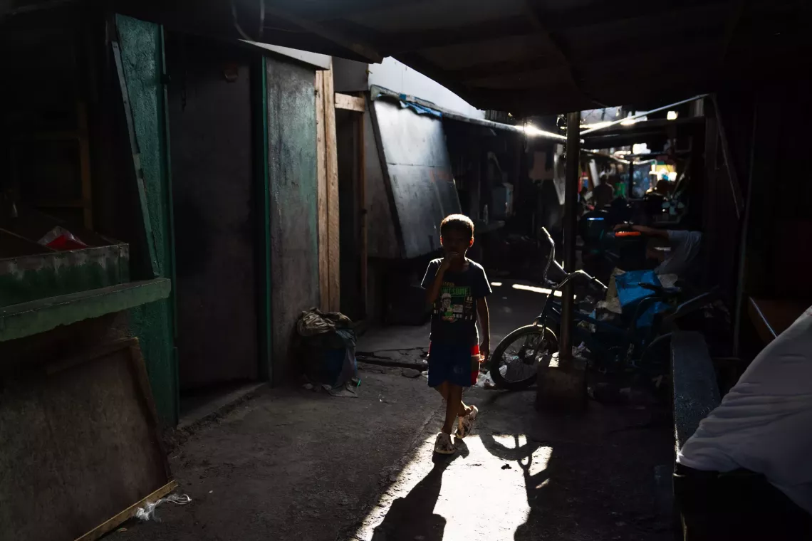 A child in a dark wet market