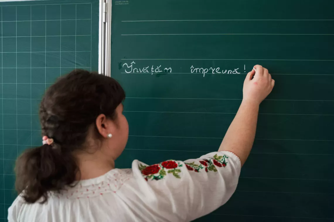 Republic of Moldova: A girl writes on a blackboard in class