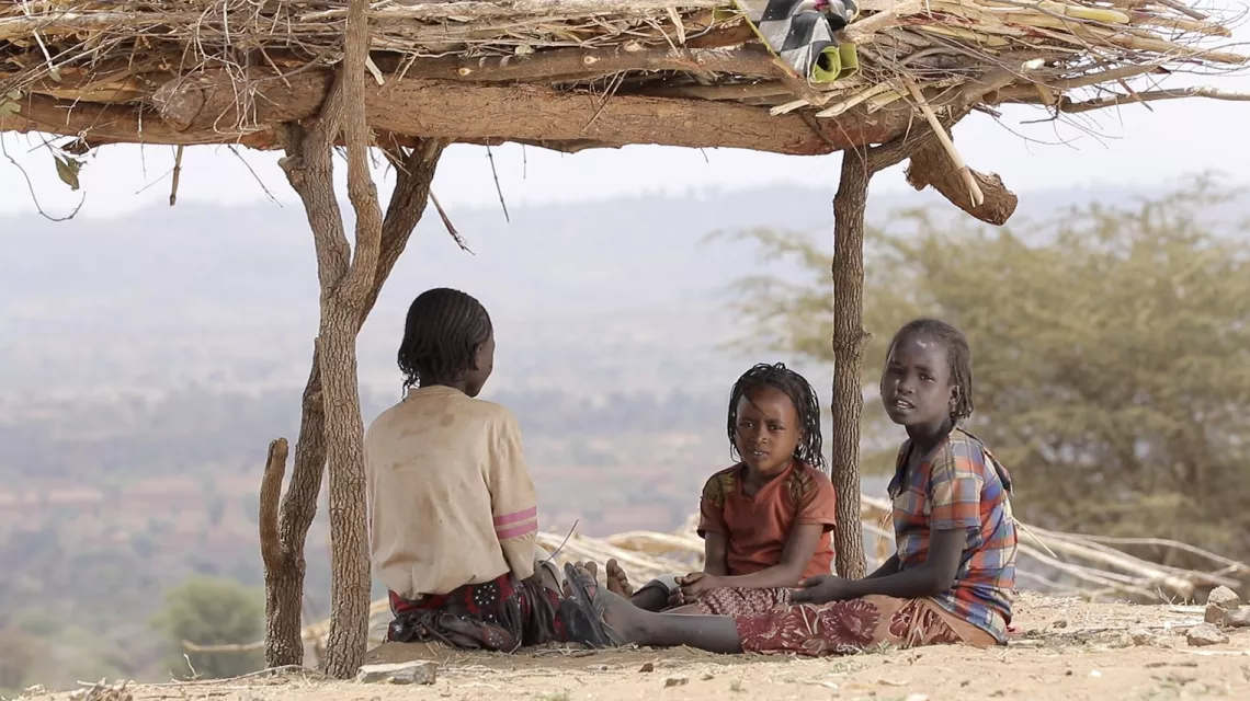 Ethiopia. A girl sits with her friends at a displacement camp.