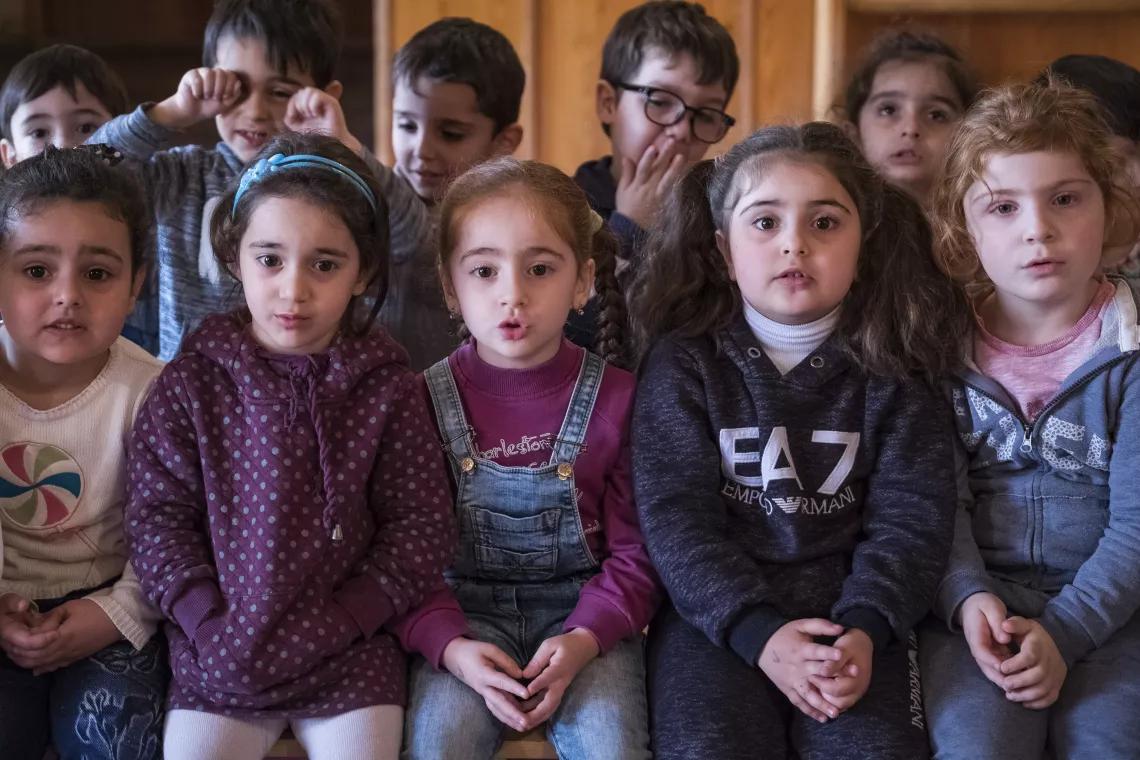 Children with developmental delays and disabilities sing together in a music class.