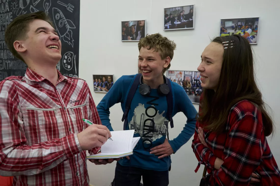 Three laughing adolescents