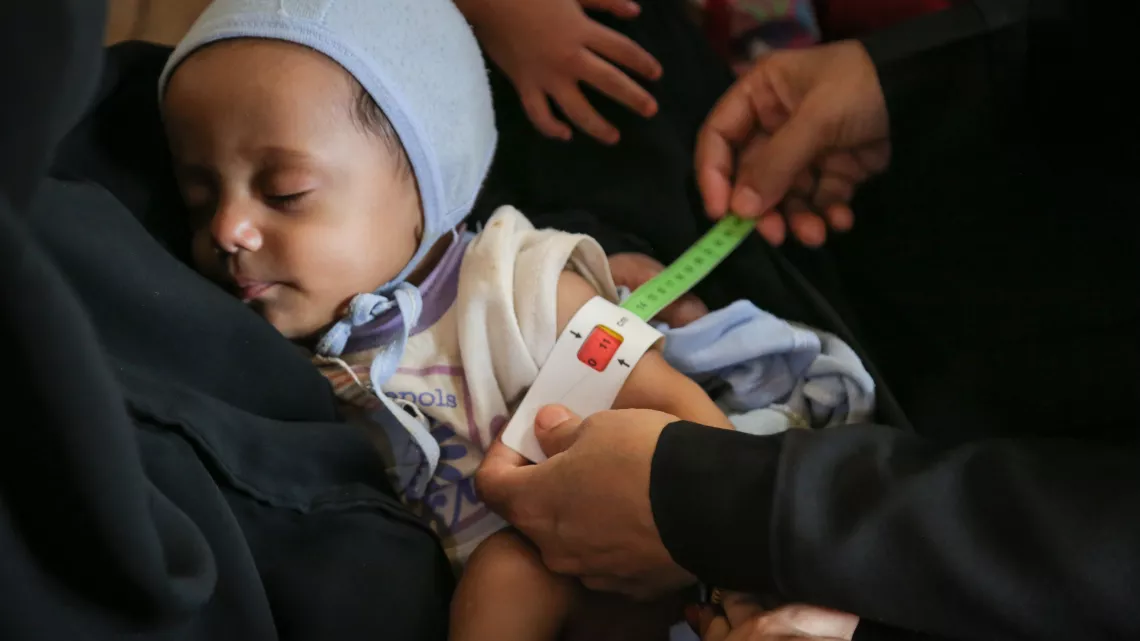 Yemen. A child's arm is measured at a health centre.