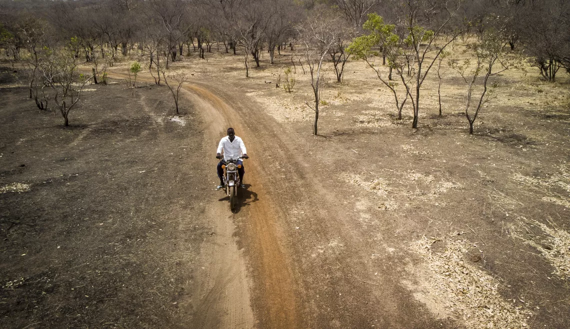 Adama travels by motorcycle to villages that are up to 50 kilometers away from the nearest health center to vaccinate children whose families live directly on informal gold mining sites.