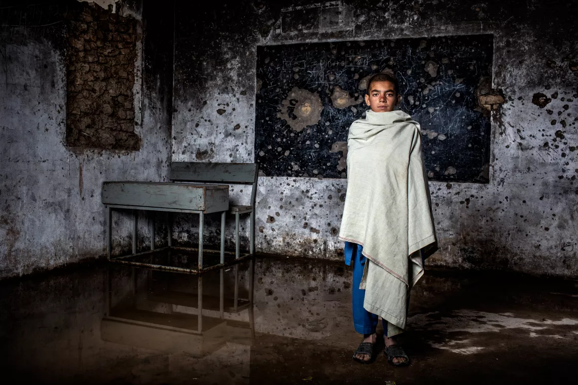 Ehsanullah, 11, stands in a classroom totally destroyed in the fight between anti-government elements and the US forces in 2007
