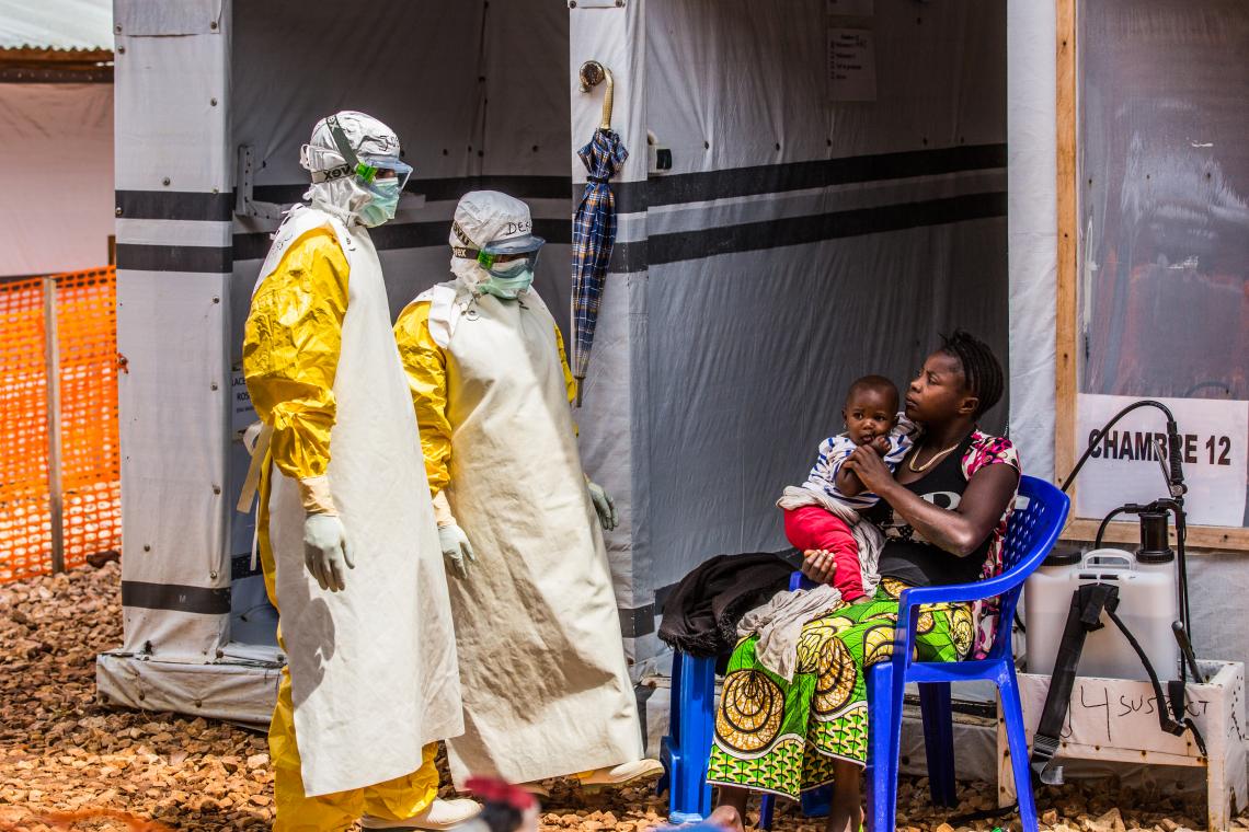 Democratic Republic of Congo. Health workers visit a woman and her daughter in the quarantine area of an Ebola treatment centre in North Kivu province.
