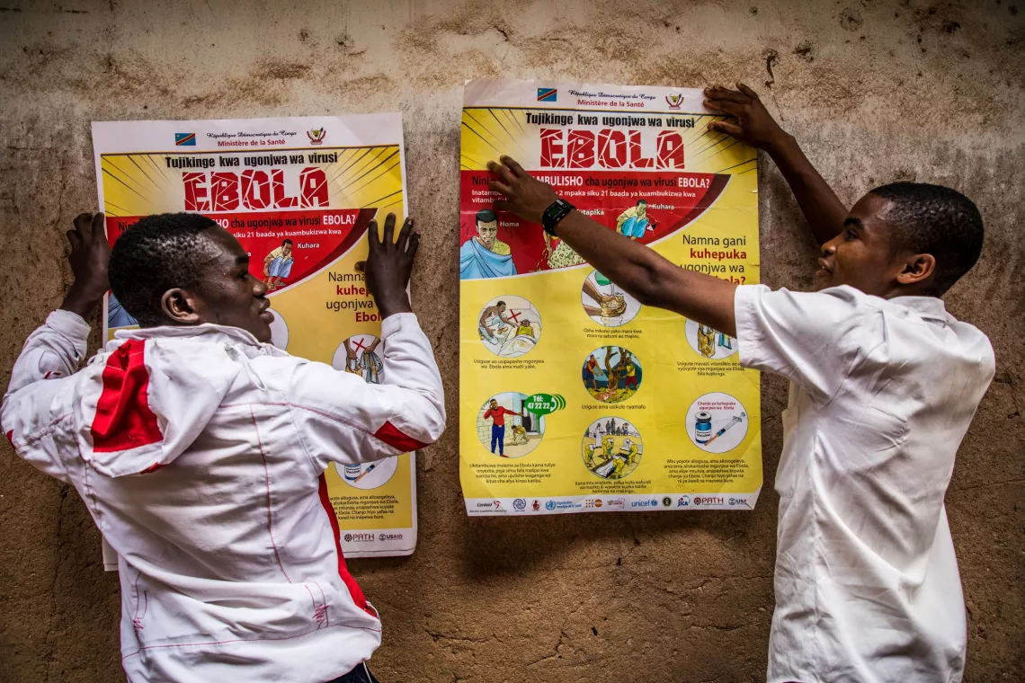 Democratic Republic of the Congo. Students put up a poster detailing Ebola sensitization at a school in Butembo.