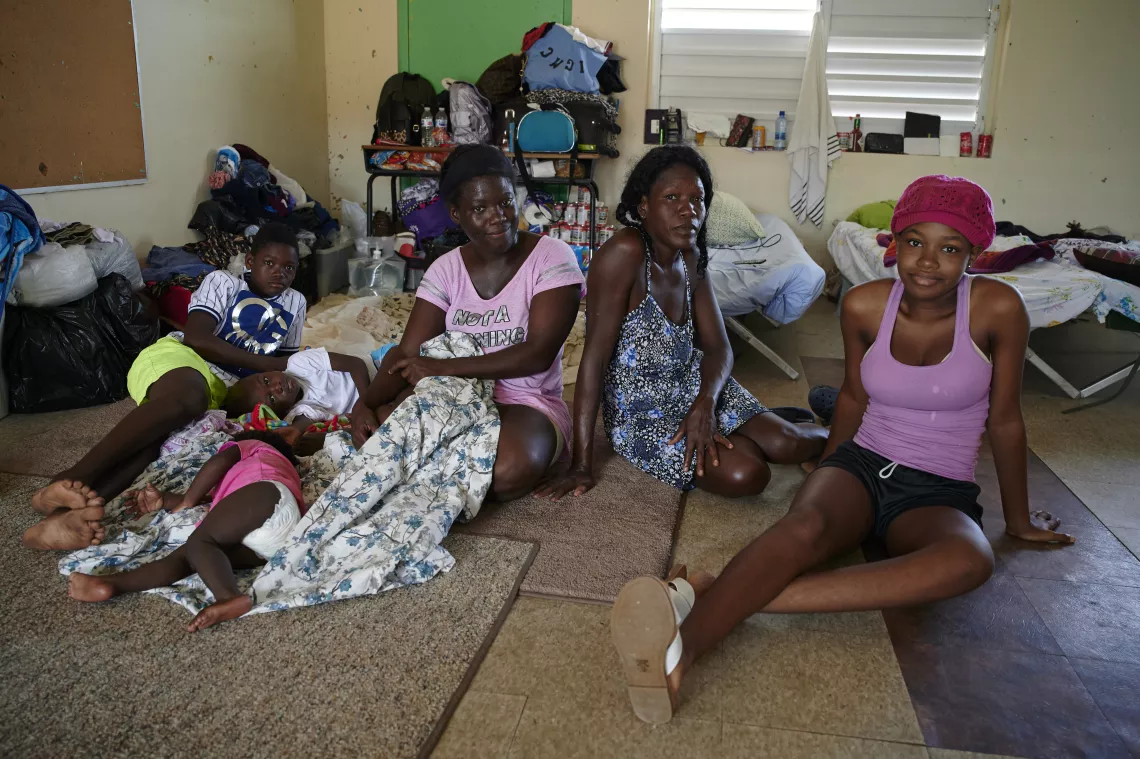 Woman and children inside a temporary shelter