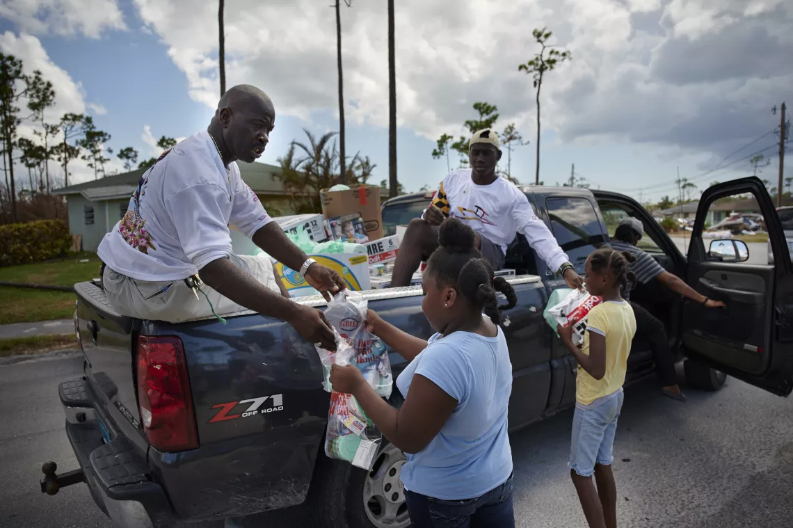 People collect supplies from a NGO on Grand Bahama.