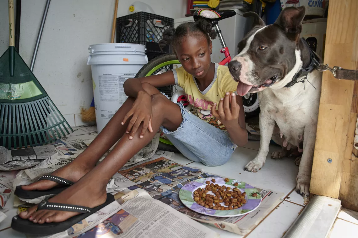 A girl feeds her dog
