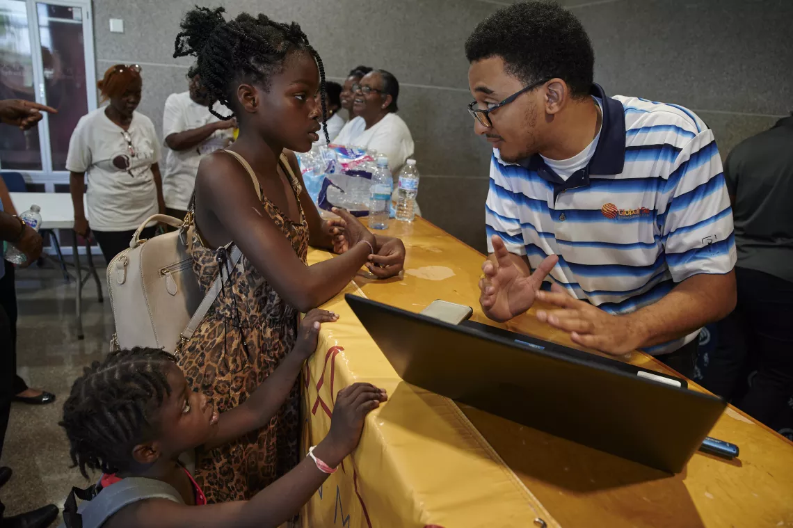 A girl receives education supplies. 