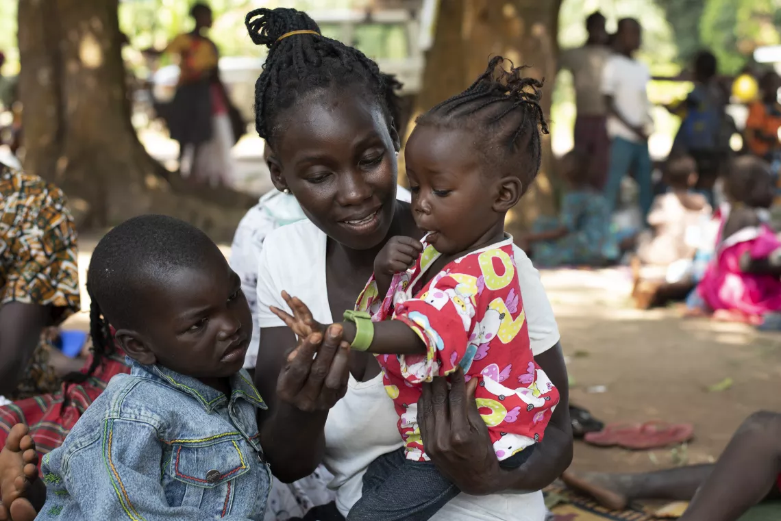 South Sudan. A woman holds her child.