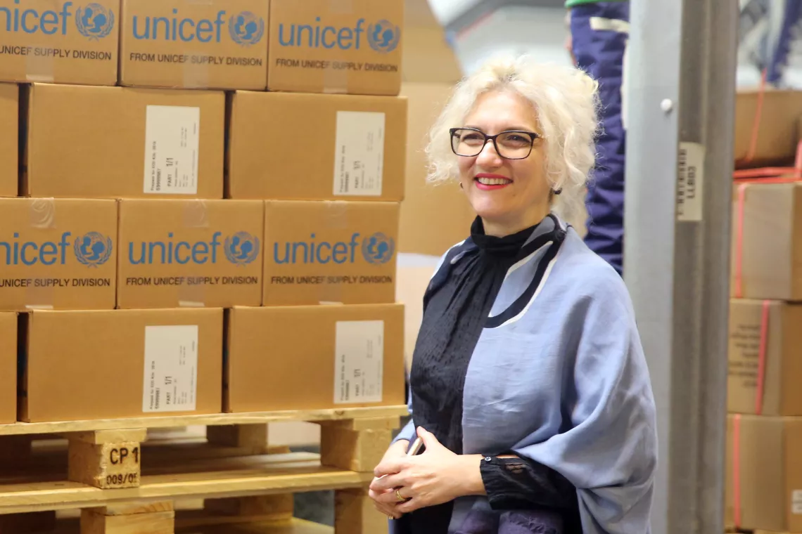 Etleva Kadilli, the Director of UNICEF&rsquo;s Supply Division, stands in front of supplies at the warehouse in Copenagen, Denmark.