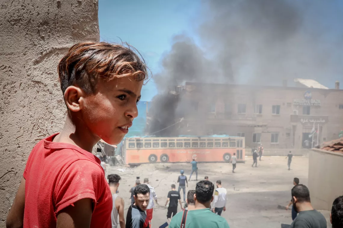 Gaza. A child stands near a damaged building at the port of Gaza.