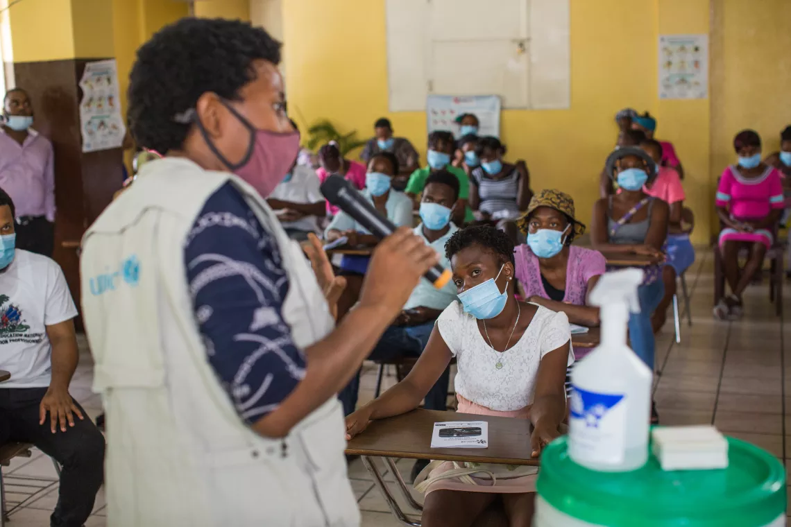 UNICEF's B&eacute;rang&egrave;re Antoine explains the benefits of the vaccine against COVID-19 during a meeting at the Saint Antoine Church in Port-au-Prince, Haiti.