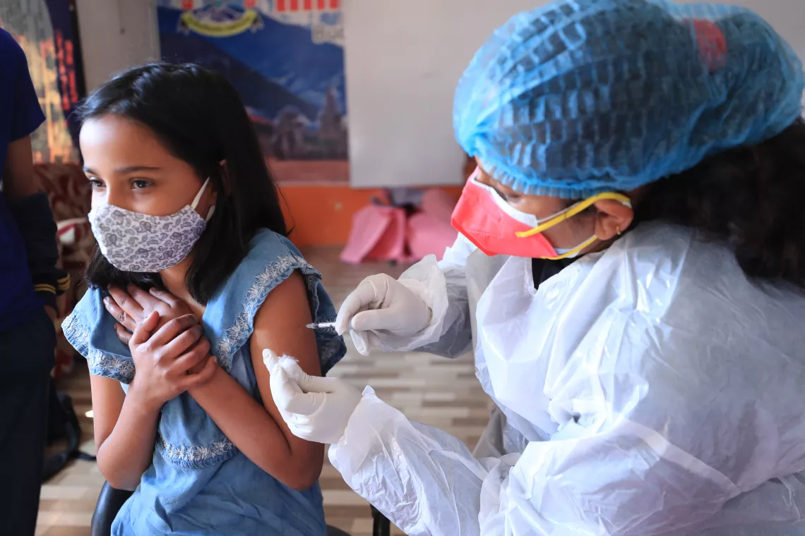 12-year-old Jessica Dhakal from the Himalaya Boarding School in Budhanilkantha, Nepal, receives a COVID-19 vaccine.