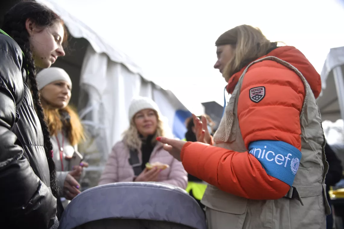 A group of refugees seeks support and information at the first established Blue Dot, at the Sighetu Marmatiei border crossing in Romania, on 1 March 2022.