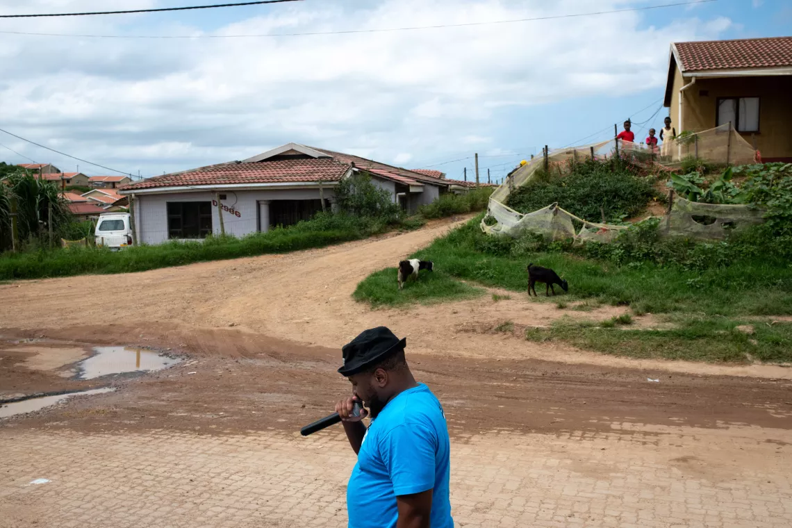  Sandile Khanylie, a mobiliser with the Zwakala campaign, encourages community members to visit a pop-up vaccination clinic near Lindelani-Ncada taxi rank in Ntuzuma, Durban, South Africa.