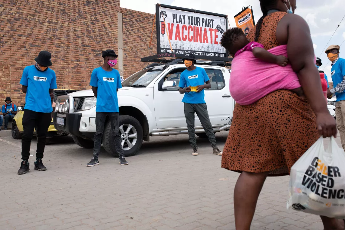 On 9 February 2022, mobilizers distribute pamphlets and broadcast music and messages from a truck-mounted PA system which encourage passersby to get vaccinated at the Swazi Inn shopping center and transport hub in Ivory Park, Thembisa, South Africa.