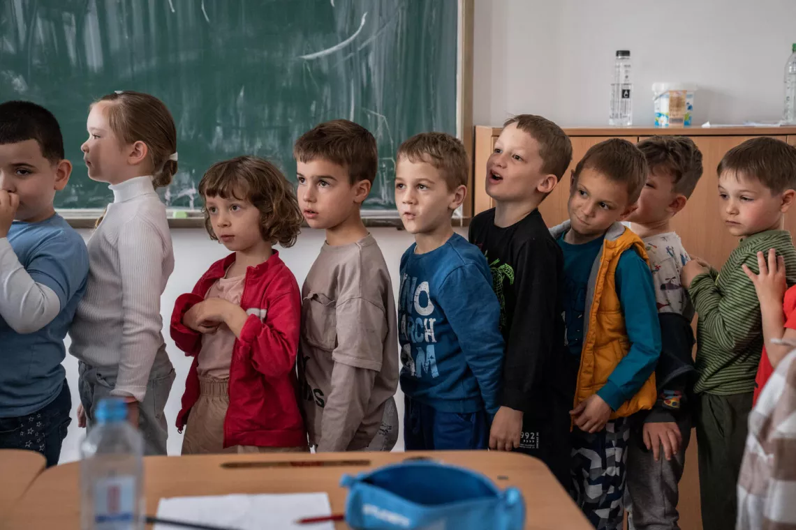 Romania. A group of students line up in class.