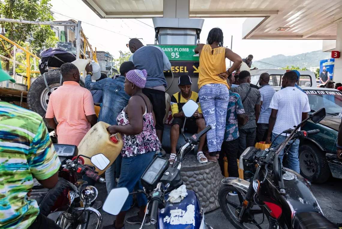 Motorcyclists and other drivers crowd around a gas pump at a station in a suburb of Port-au-Prince amid fuel shortages.