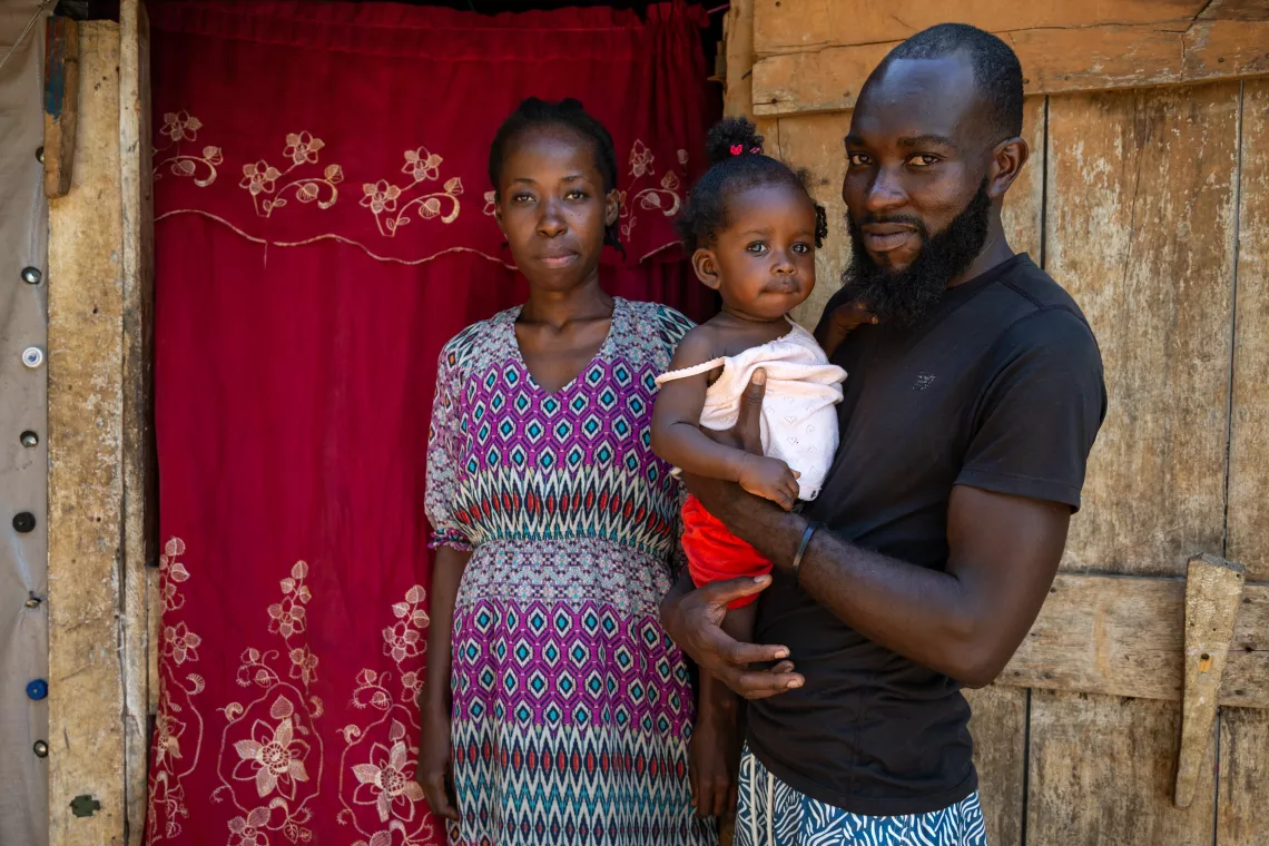 Mother Casmus Joseph and father Claudy D&eacute;lice stand for a portrait with their 9-month-old daughter, Anne-Djouna&iuml;ka