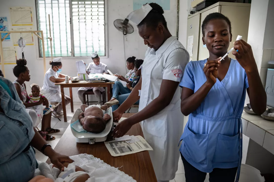 Nurses attend to a baby in the vaccination centre at Hopital Immacul&eacute;e Conception, the largest hospital in Les Cayes.