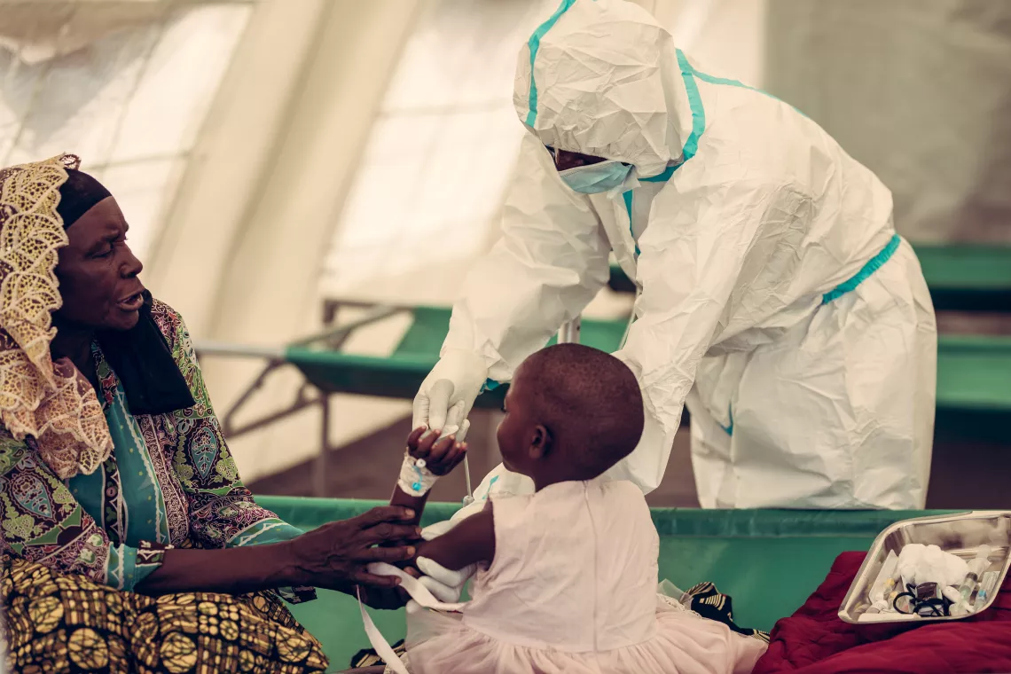 A child in Malawi receives cholera treatment from a health worker at the Chilumba rural hospital. 
