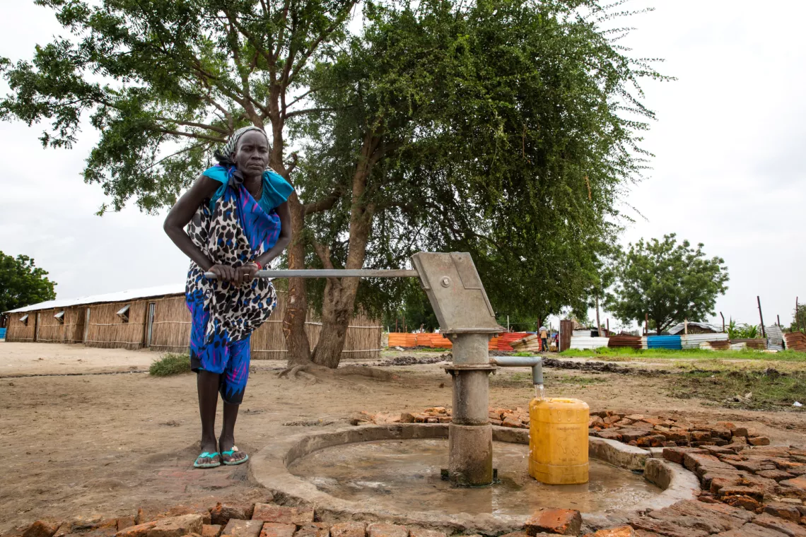 Angelina Nyakuma pumps water into a jerry can