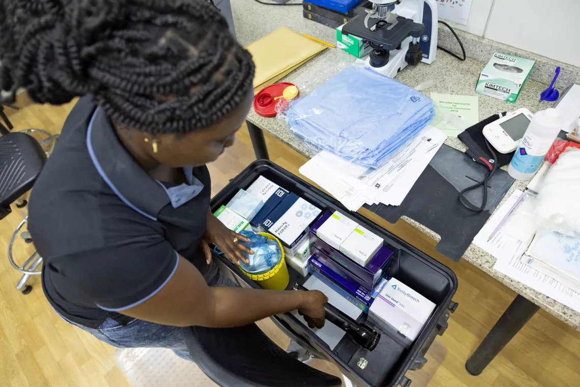 Hortance Nelson (Microscopist Superviser) packing for a field trip to give medical supplies and training to MSDs in remote migrant mining communities in the Amazon Jungle at the TropClinic Paramaribo Suriname.