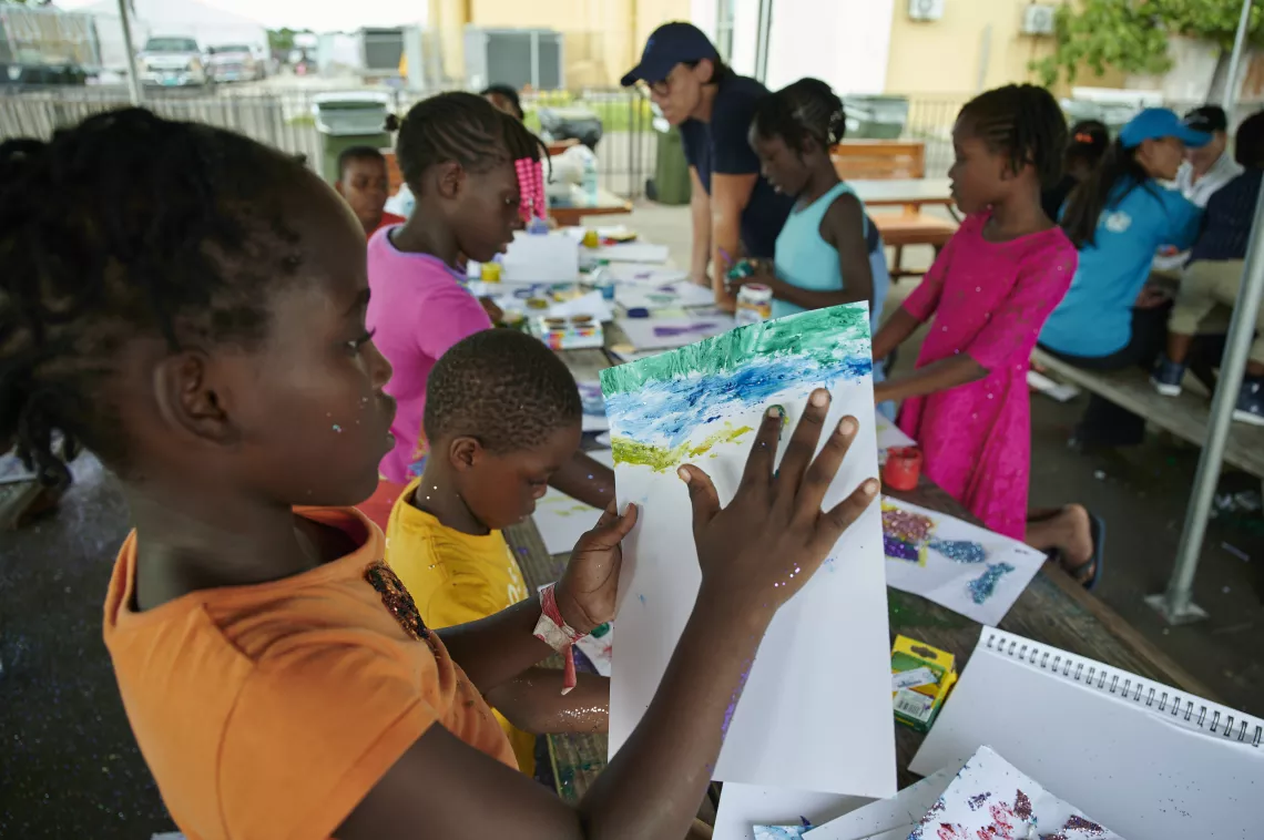 A girl paints at a shelter
