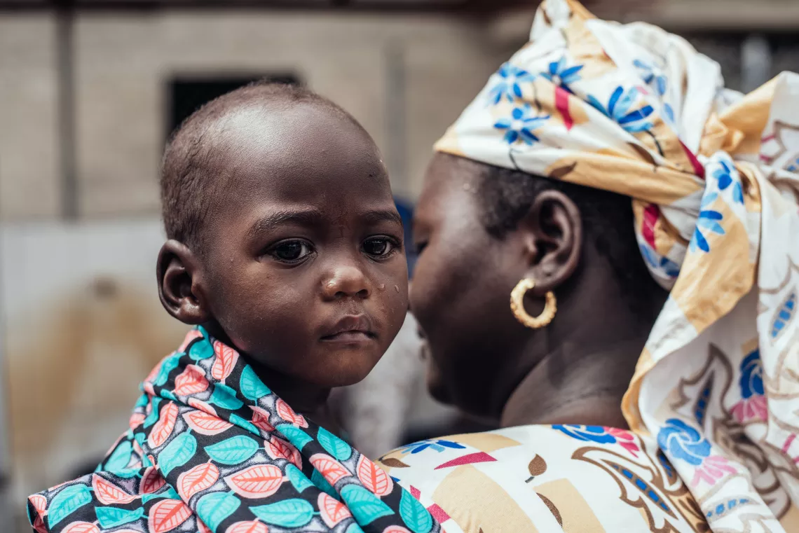 Nigeria. A woman holds her child.