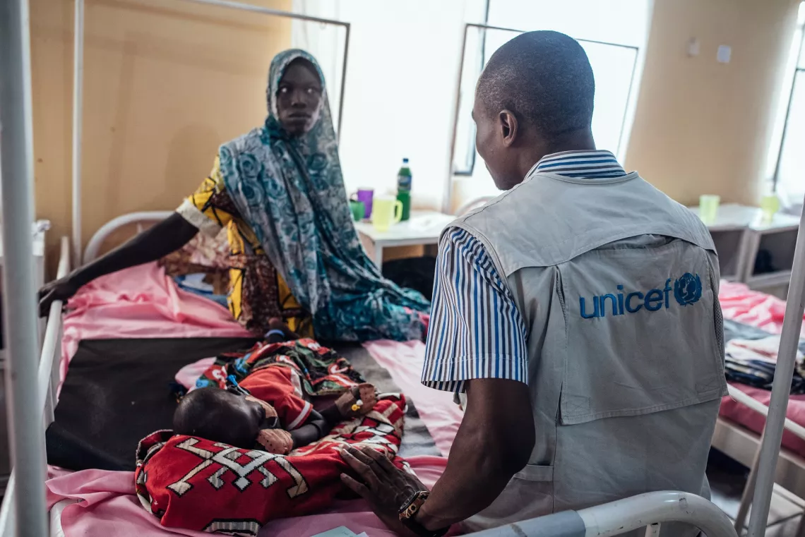 Nigeria. A woman talks with a health worker.