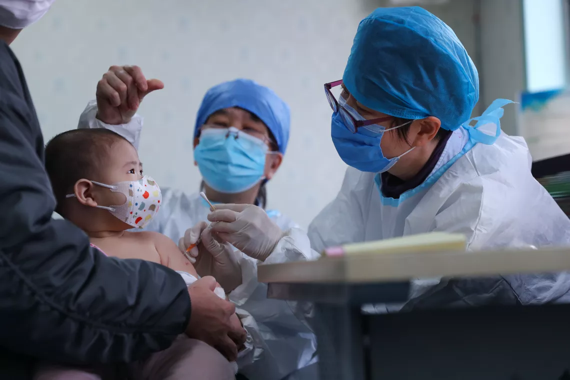 A 6-month baby receives a delayed vaccine shot at a community health centre in Beijing, China, on 26 March 2020. 