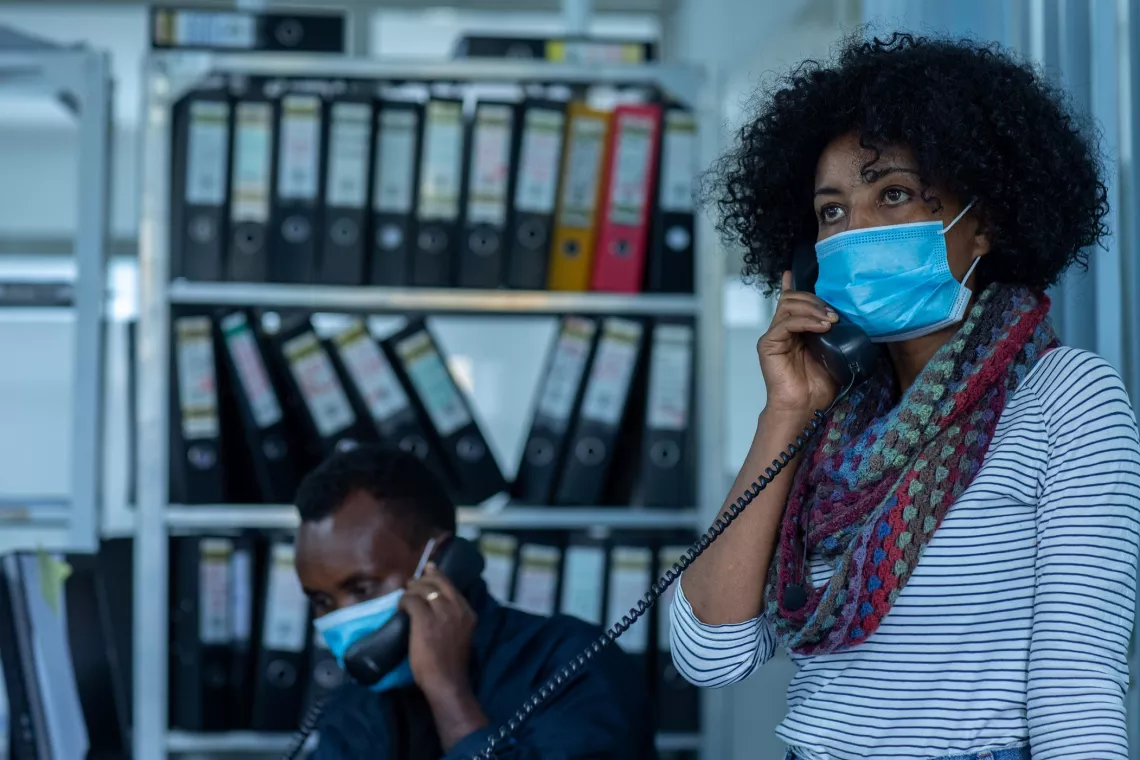 Ethiopia. A social worker talks on the phone.