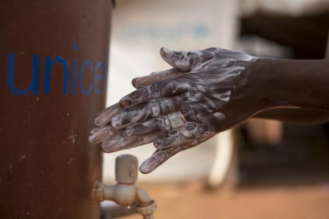 Mali. A girl washes her hands.