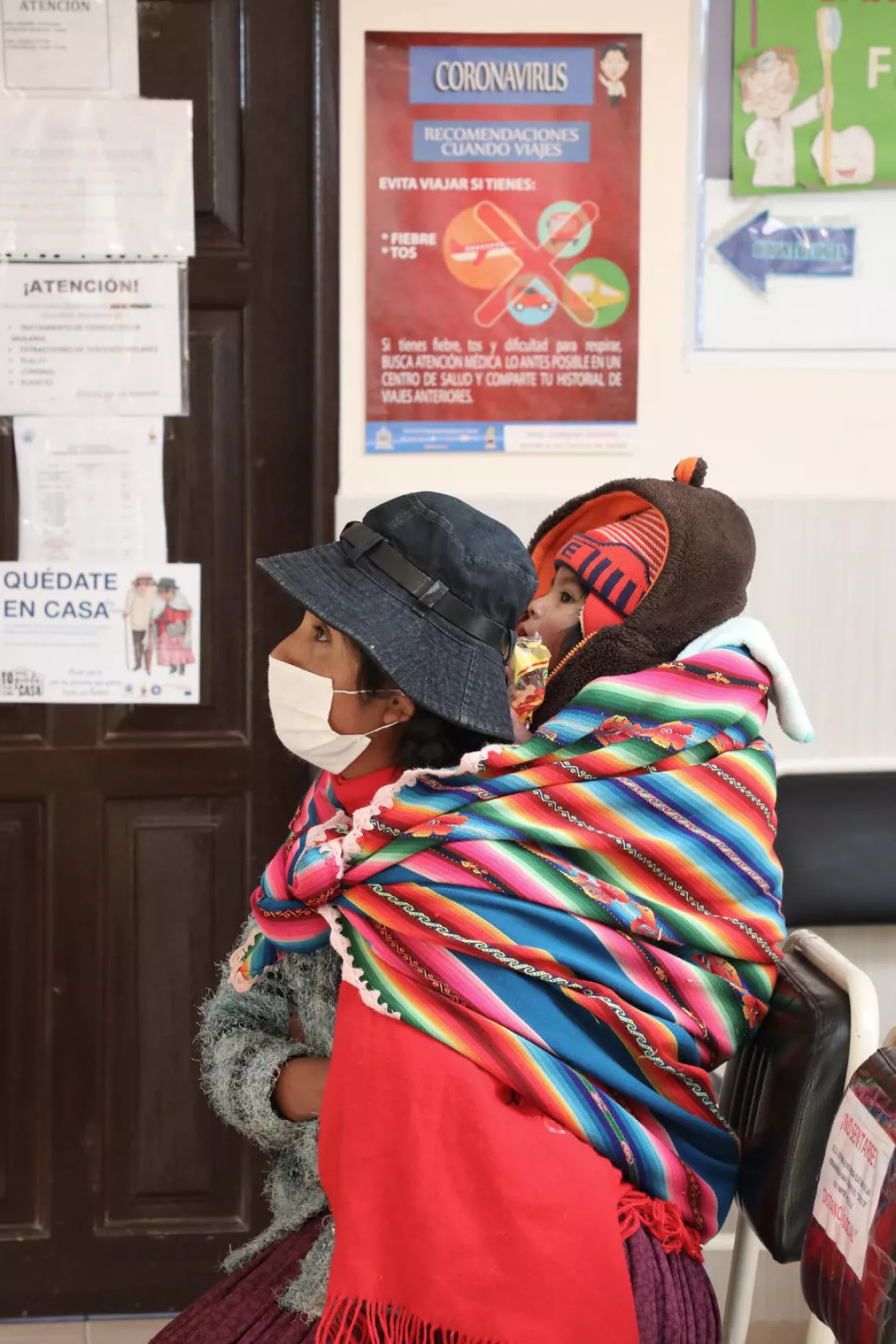 Jonatan and his mother wait to be seen at the Los Pinos health centre in El Alto, Bolivia, on 26 May 2020. 