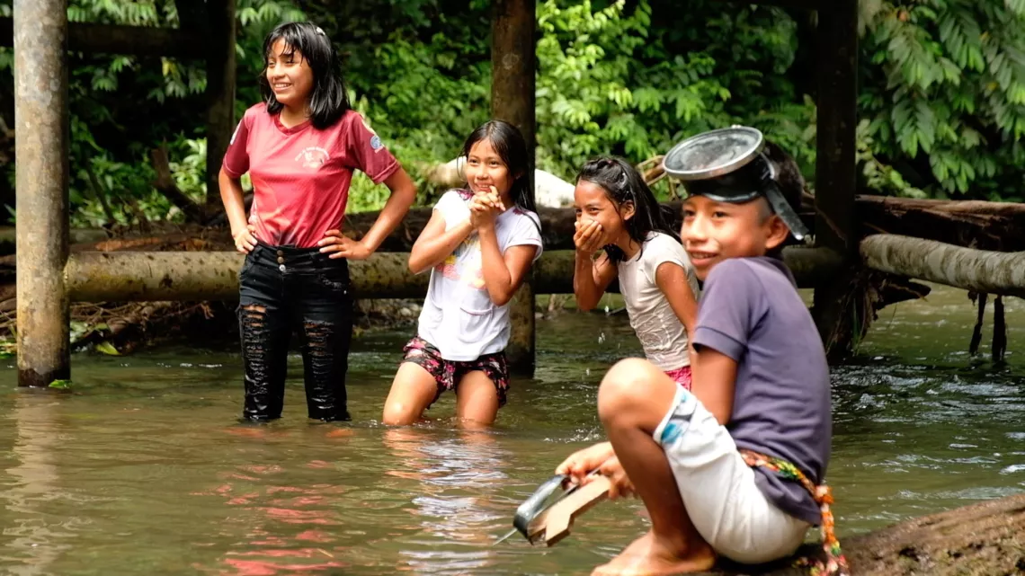 Ecuador. Children play in a river.
