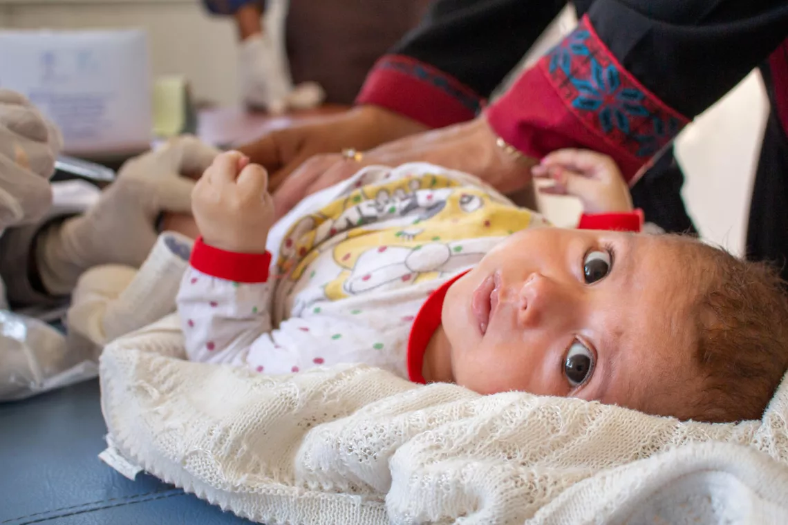 Three-month-old Zuka receives her vaccines at a temporary clinic provided by UNICEF in eastern Aleppo, Syria, on 16 June. 