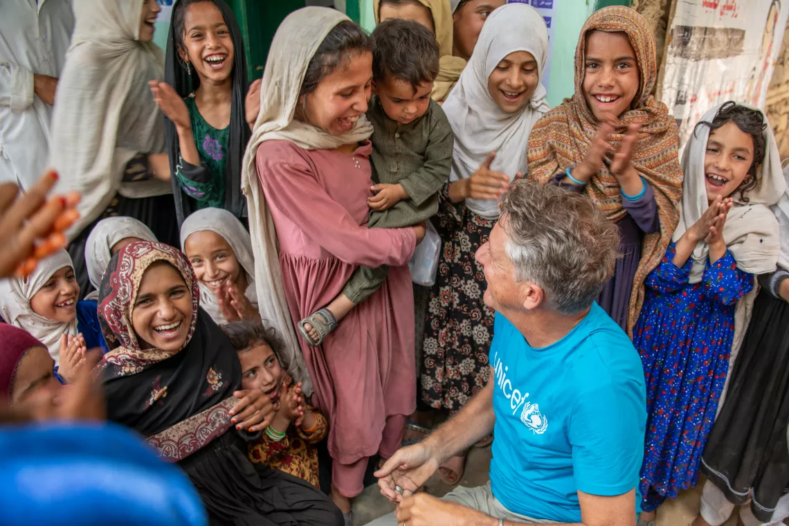 Afghanistan. James Elder plays with a group of children during a UNICEF-supported mobile health and nutrition team visit.