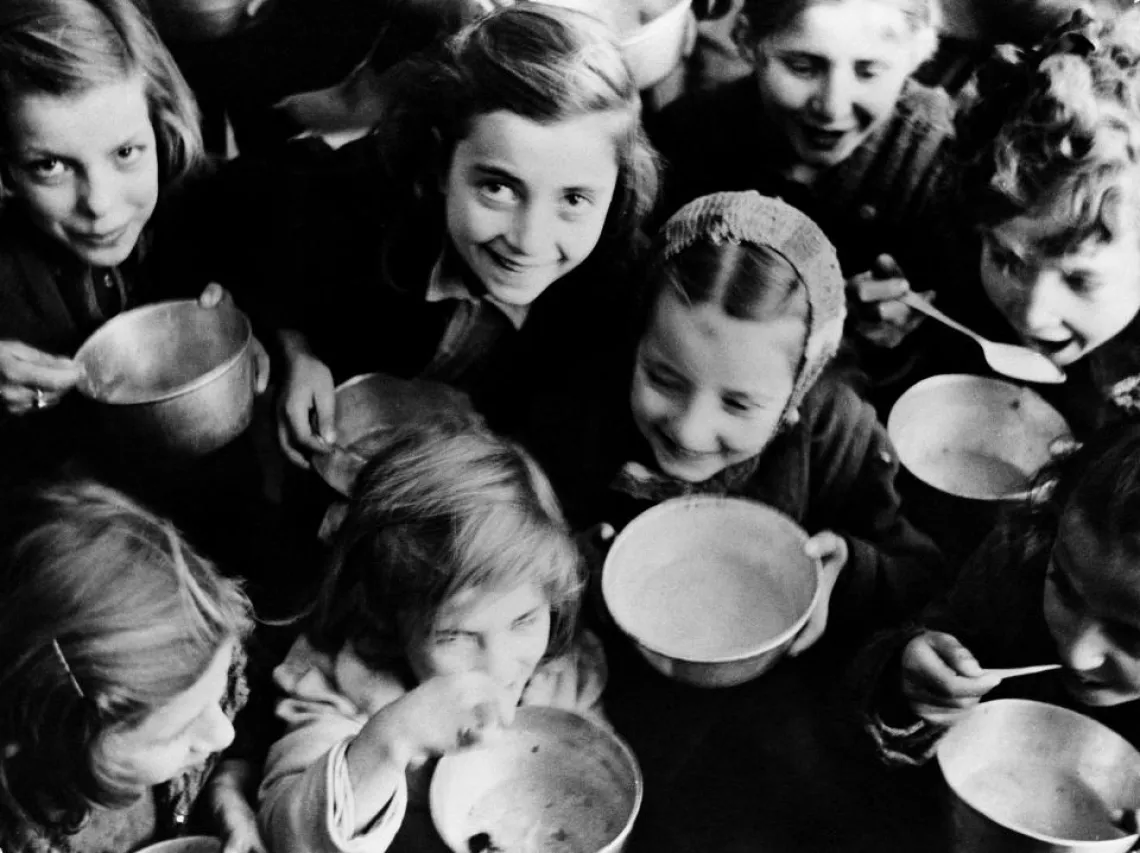 Children in Patras, a north-western port city, eat cereal provided by the United Nations Relief and Rehabilitation Administration. Greece, 1946.