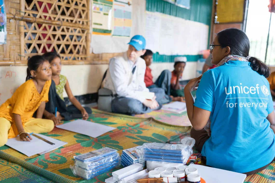 Bangladesh. Shatabdi Khastagir (right), a UNICEF Child Protection Officer, talks to children during a group activity at a Multi-Purpose Centre in a Rohingya refugee camp in Cox&rsquo;s Bazar.