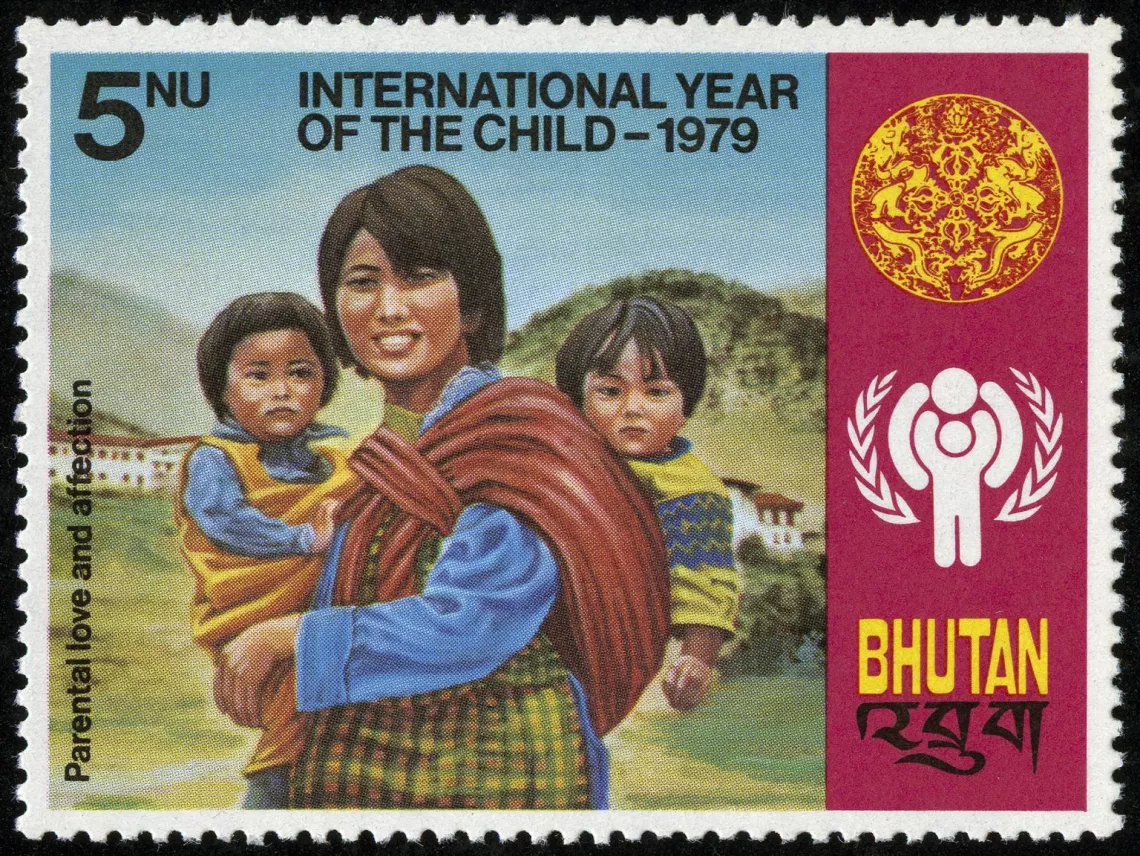 A stamp from Bhutan shows a mother with her two children.