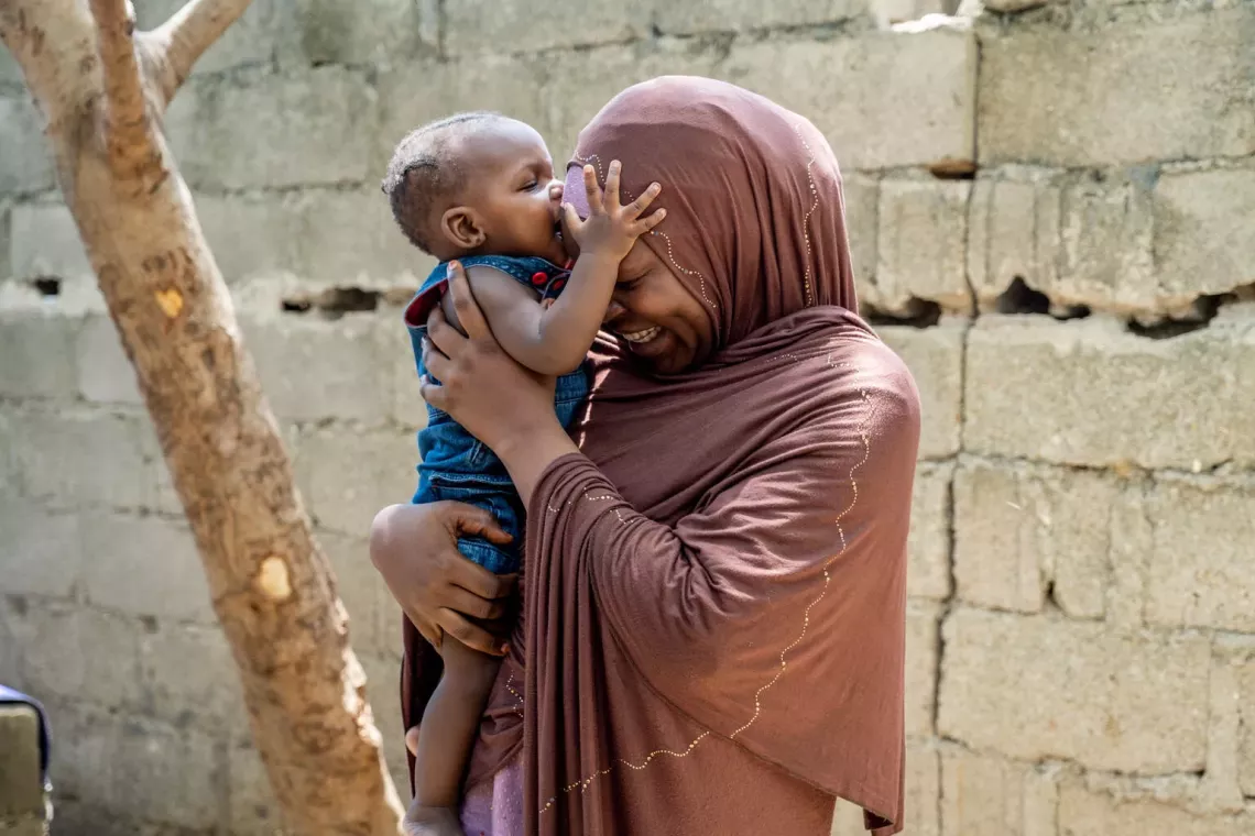 Khadija, 32, plays with her daughter at their home in Miri, Nigeria. 