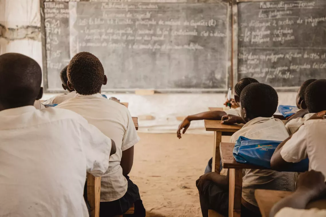 Schools attend class in a temporary learning space in Democratic Republic of Congo.