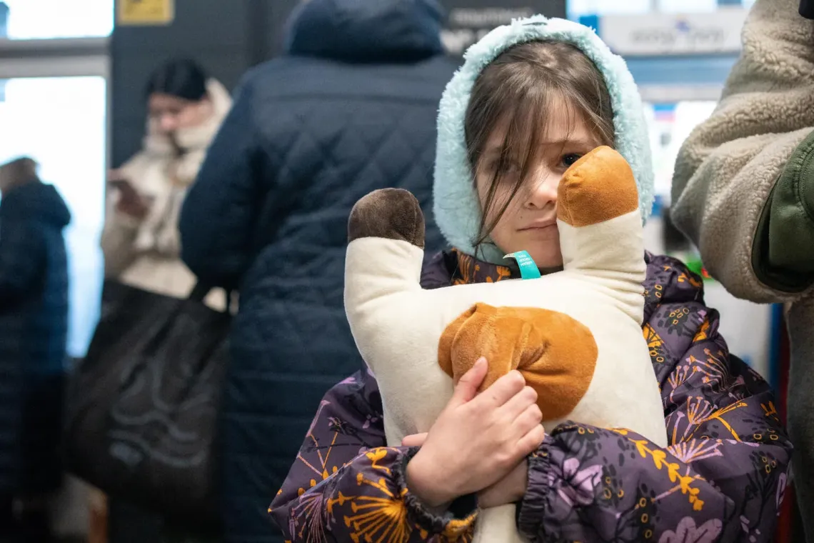 Ukraine. A girl hugs her toy as she takes shelter in a Kyiv metro station.