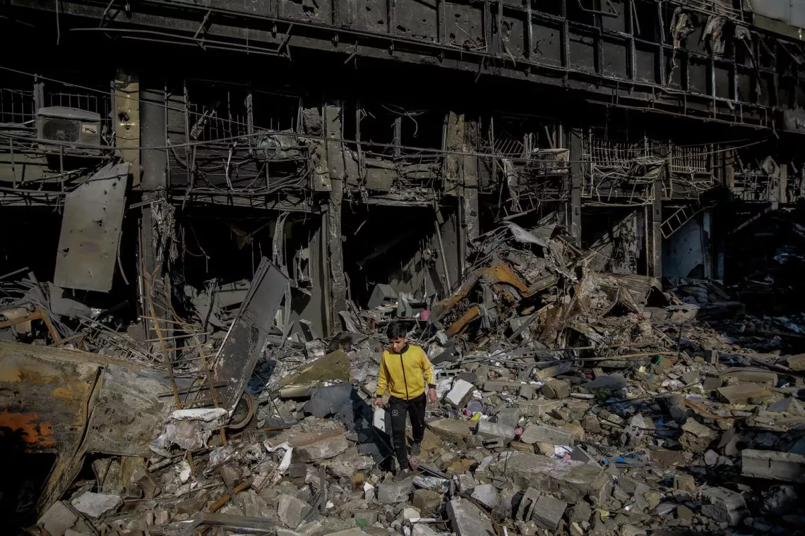 Gaza Strip. A boy walks over the rubble of his destroyed home in&nbsp;Gaza City.