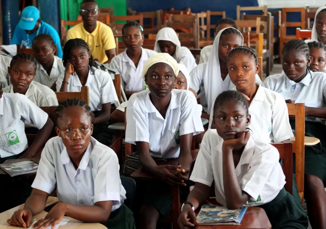 School children sitting at their desks in a classroom.
